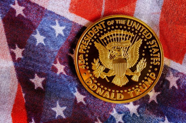 New York NY NOV 12 2019: Presiden Donald Trump coin against US flag background in the election 2020
